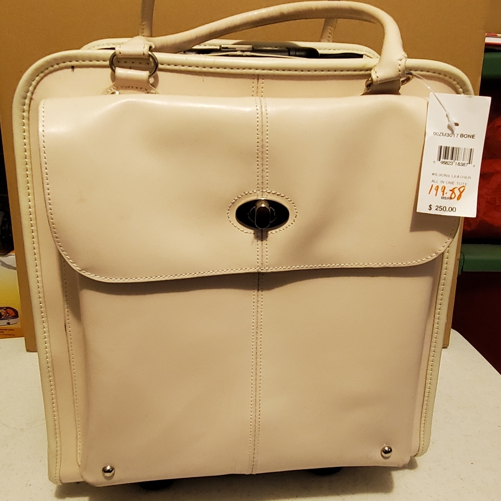 Wilson Leather travel case with wheels.